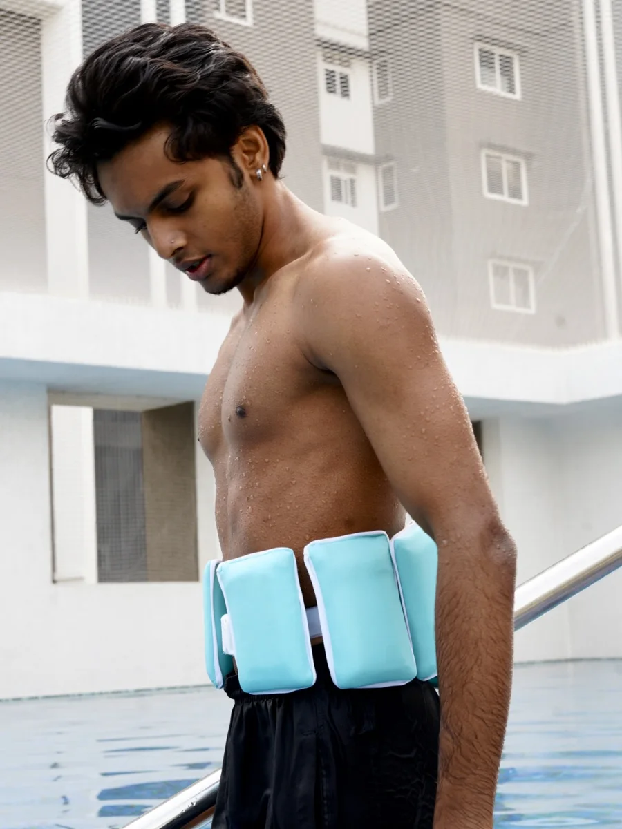 A man looking down at the blocks at his waist