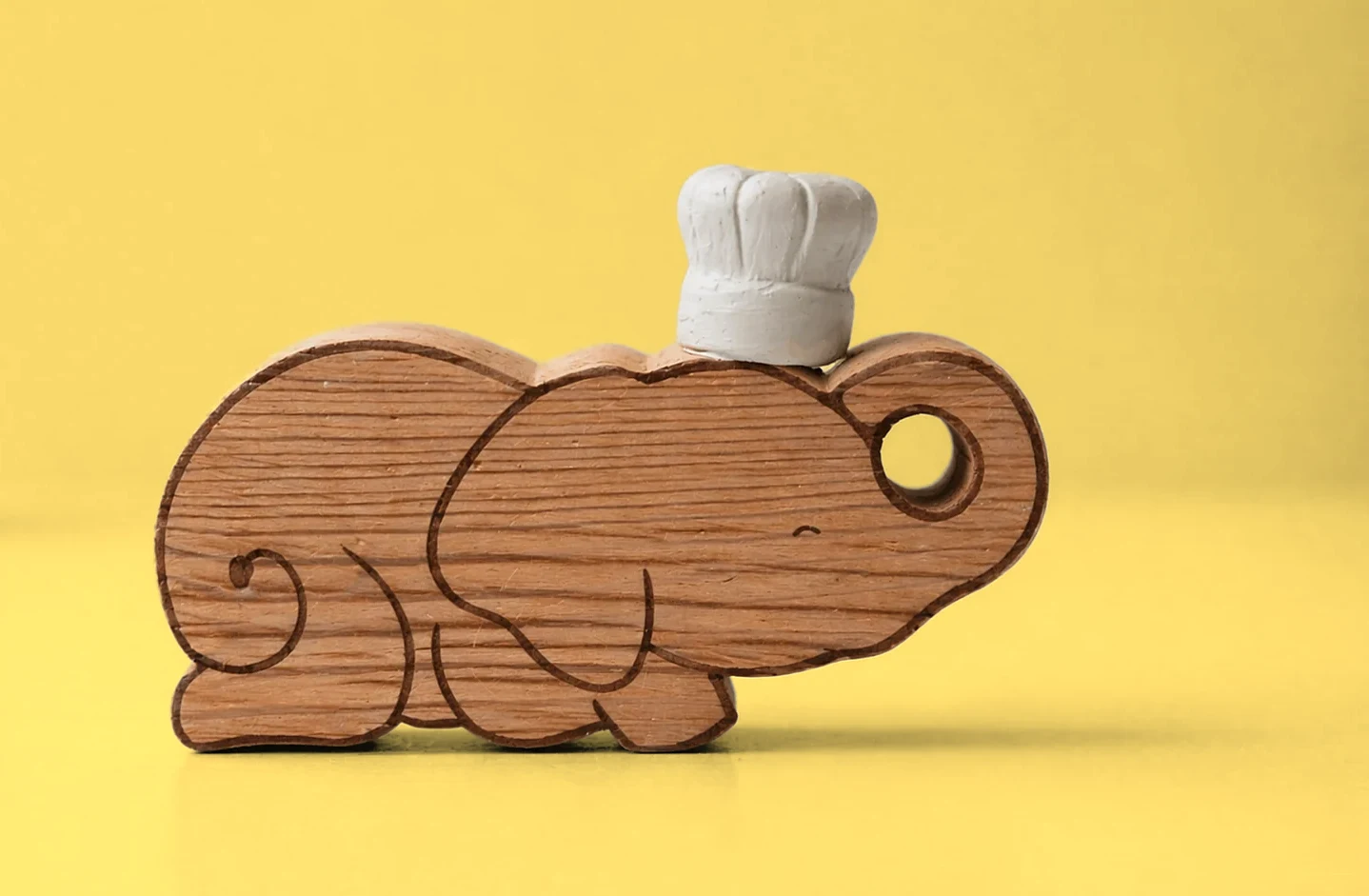 Ellie wearing the white chef’s hat, on yellow
