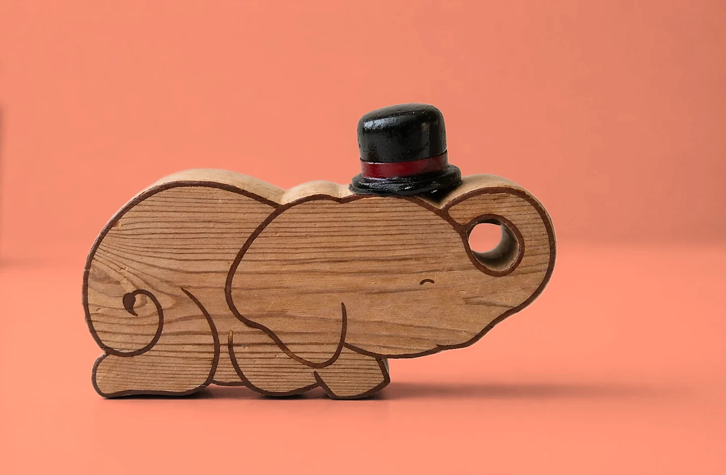 Ellie wearing the black top hat with a red band, on coral