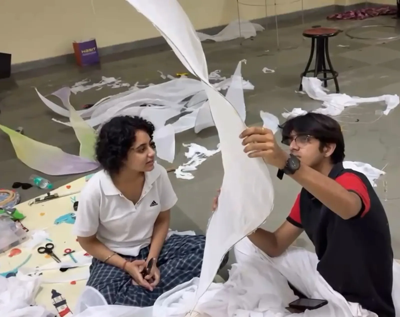 Two of the team shaping the organza leaves on the studio floor