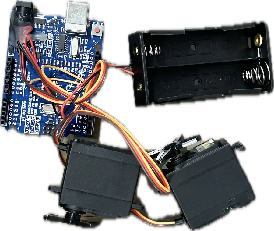 An Arduino board, a battery holder and two servo motors