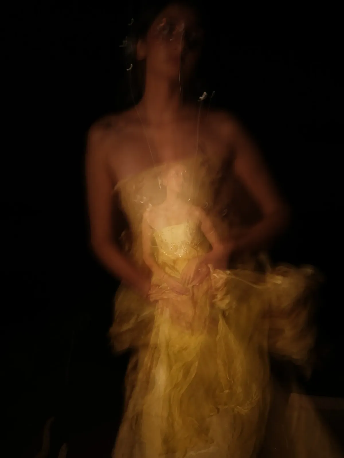 Long exposure: the yellow gown dissolving into light