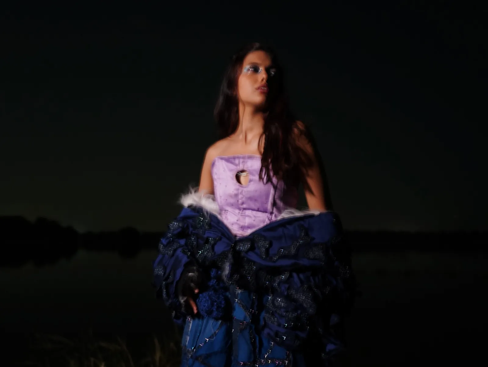 The lilac corset and navy coat by a lake at night